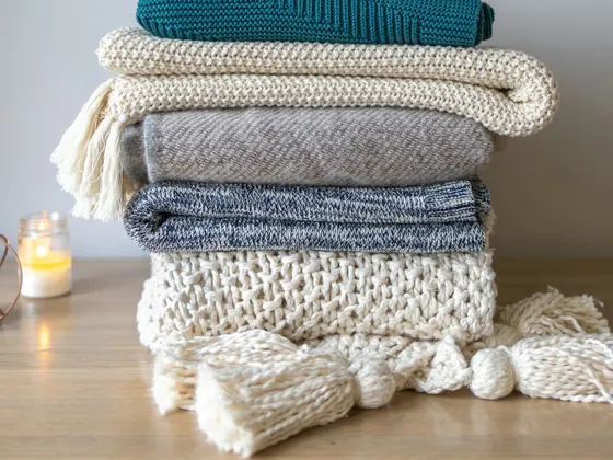 A bed made up with cotton bedding